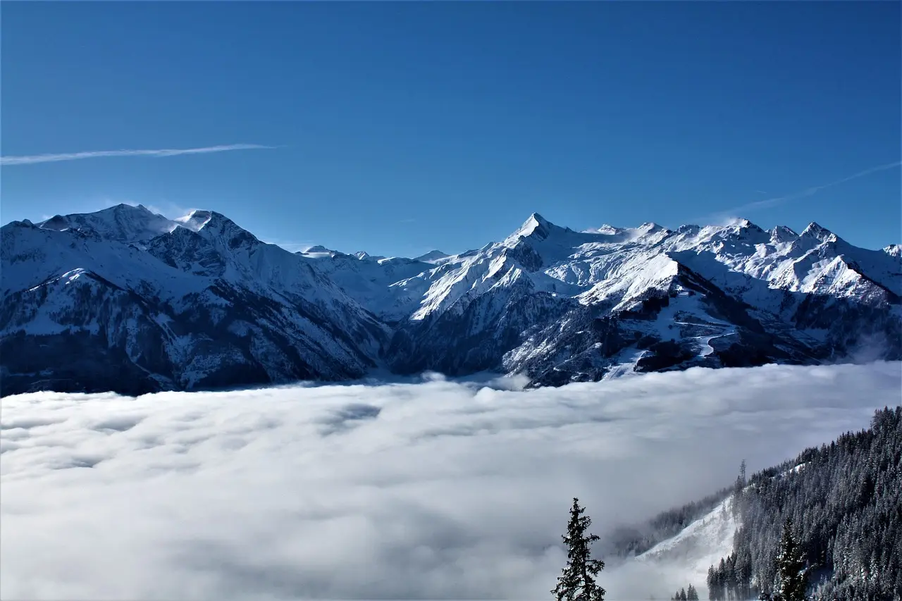 Snow-covered peaks rising above a sea of clouds